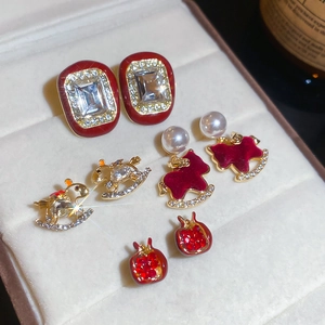Set of four red enamel and rhinestone earrings in a gift box with holiday theme