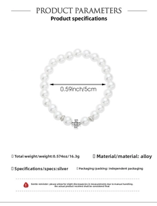 Macro detail of baroque pearl bracelet with silver cross charm and weight specifications