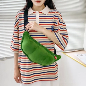Adjustable strap detail on a soft green pea pod shaped plush crossbody shoulder bag