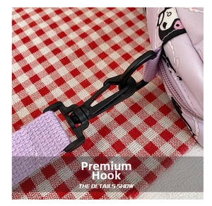 Detail showing the durable black hook and purple shoulder strap of the cartoon bag