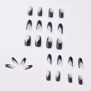 Matte black and white butterfly press-on nails set in elegant oval shape design