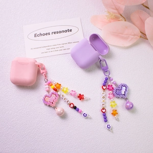 Pink and purple silicone AirPods cases with LOVE lettered beads and pixel heart charms