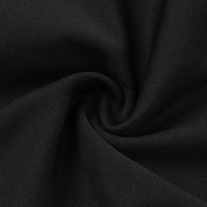 Macro shot of high-quality black tweed fabric texture with intricate woven spiral detail