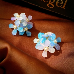 Detail of blue purple gradient flower earrings with resin petals and pearl centers