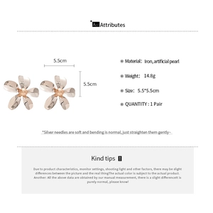 Detailed view of metal flower earrings with pearls and 5.5cm size specifications