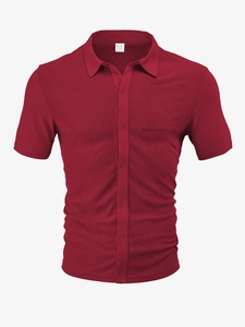 Detail of burgundy polo shirt featuring a textured herringbone knit and front chest pocket