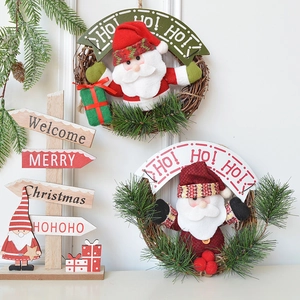 Christmas wreath set with Santa Claus plush figures, pine needles, and wooden signs