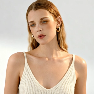 Minimalist gold metal crinkle hoop earrings for women shown on a fashion model