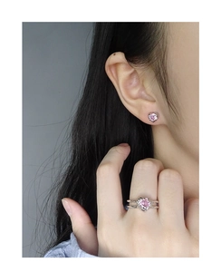 Macro detail of the S925 silver ring and earrings set with pink heart zirconia stones