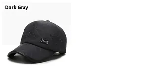Detailed close-up of dark grey quilted baseball cap featuring a silver metal logo plaque