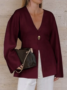 Detail view of burgundy V-neck long sleeve blouse with button design for women