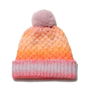 Close-up of winter knit hat featuring vibrant gradient yarn and a fluffy faux fur pompom
