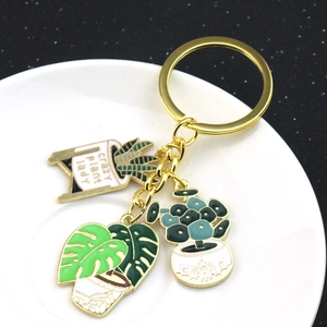 Golden enamel succulent plant keychain featuring monstera and crazy plant lady potted charm
