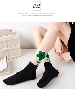 Detail of floral crew socks with green patterns and a black-and-white color block design