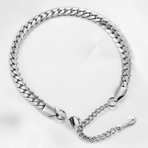 Close-up of 6mm silver stainless steel Cuban link bracelet with lobster clasp on fabric