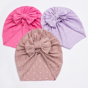 Detail of baby lace turban hats with bow in rose, purple, and brown-pink colors