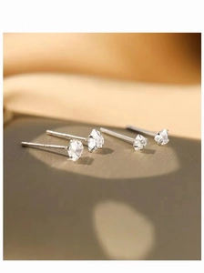 Macro shot of S925 sterling silver heart studs with sparkling clear zircon stones