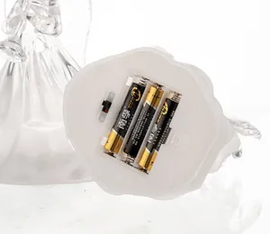Detail view of the LED angel statue base showing battery compartment and power switch