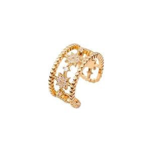 Golden double-layer open star ring with white zircon stones on a white background