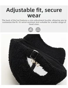 Detail view of adjustable metal buckle on black faux shearling winter baseball cap