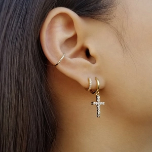 Detailed close-up of S925 silver gold hoop earrings with cross charm and pave zircons