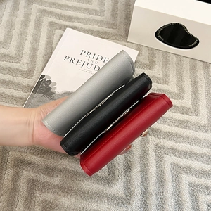 Three-fold minimalist women's mini wallet in grey, black, and red leather finish