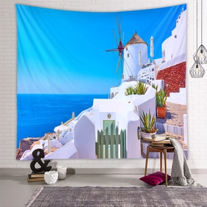 Detail of Santorini landscape tapestry with white buildings and windmills on a brick wall