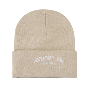 Beige knit beanie hat featuring Brooklyn EST 1634 embroidery with a stylish folded cuff