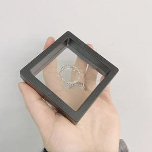 Close-up of two-tone silver and gold ring in black suspension jewelry display box