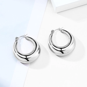 Detailed view of silver U-shaped hollow hoop earrings with a polished mirror finish