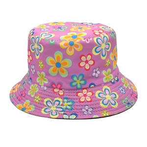 Close-up of pink bucket hat featuring colorful floral print and cotton texture detail