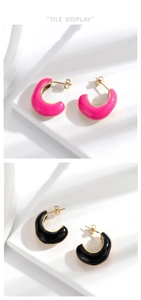 Detail showing pink and black C-shaped stainless steel earrings with glossy enamel finish