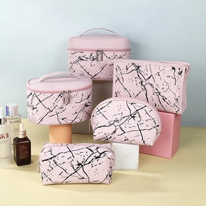 Five-piece pink marble makeup bag set including various sizes for travel storage