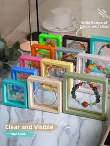 Detailed view of colorful PE film floating jewelry boxes arranged on a marble surface
