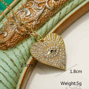Detail shot of gold heart pendant with black bead and pavé crystals, size 2.3x1.8cm