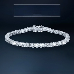 Macro view of sterling silver tennis bracelet featuring classic four-prong moissanite stones