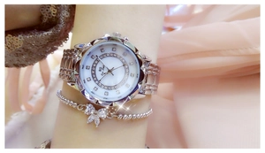 Detail showing a silver women's watch with rhinestone bezel and matching bow bracelet