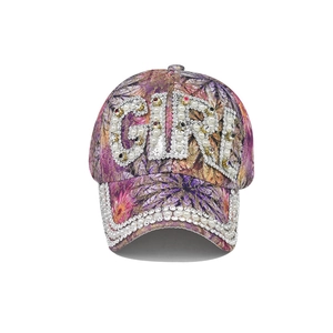 Detailed view of GIRL lettering with pearls and rhinestones on floral baseball cap