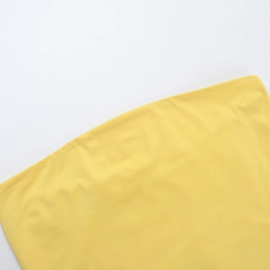 Detailed close-up of vibrant yellow ribbed knit fabric texture on a slim crop top
