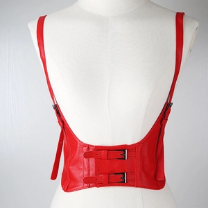 Fashionable red leather waist cincher with adjustable shoulder straps on mannequin
