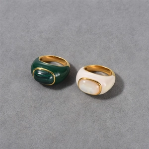 Close-up of 18k gold plated rings featuring green malachite and white mother of pearl