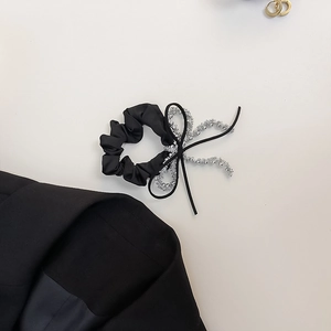 Elegant black satin scrunchie with a ribbon bow and silver bead accents for women