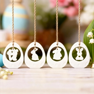 Easter egg hanging ornaments with hollowed rabbit silhouettes and LOVE text on jute rope
