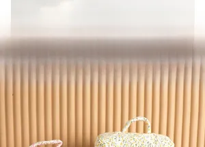 Detailed close-up of quilted floral cosmetic bag with soft cotton texture and handle