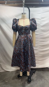 Detail view of brown satin midi dress with blue polka dots and decorative buttons