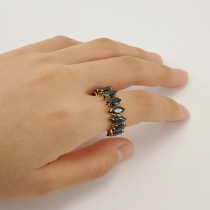 Adjustable gold plated stainless steel ring with marquise cut black gemstone on model