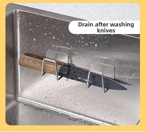Adhesive stainless steel kitchen knife holder drying on sink wall with droplets