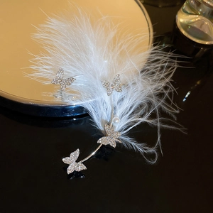 Detailed silver ear cuff with sparkling crystal butterflies, soft white feathers and pearl