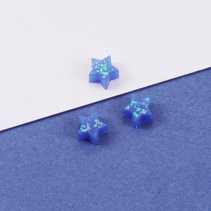 Macro shot of 8mm blue star opal beads with iridescent glitter and translucent finish