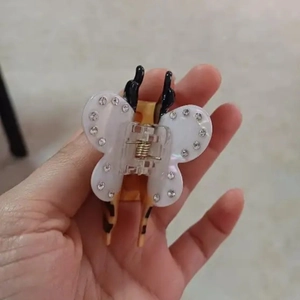 Close-up of cute bee hair claw clip with rhinestones and creative animal wing details